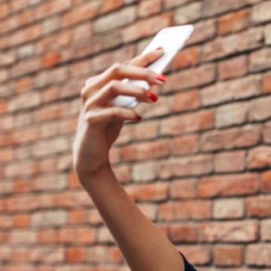 Woman shooting a selfie with iPhone XS